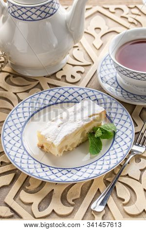 Homemade Apple Sponge Cake With Cup Of Black Tea On Oriental Wooden Table