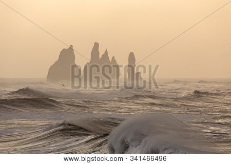 Storn On Atlantic Ocean. Breathtaking Morning View Of Reynisdrangar Cliffs With Many Gulls In The Ba