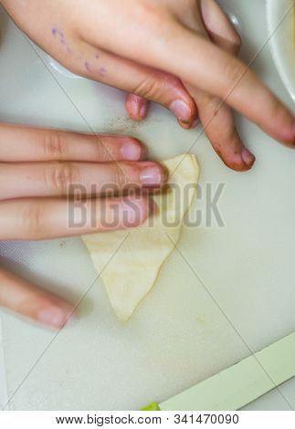 The Hands Of A Girl Prepares The Dough For Cookies
