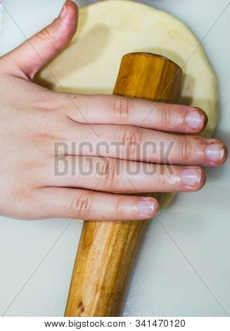 The Hands Of A Girl Prepares The Dough For Cookies