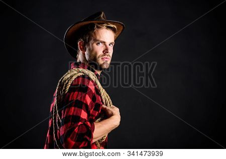 Man Unshaven Cowboy Black Background. Lasso Is Used In Rodeos As Part Of Competitive Events. Lasso C
