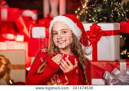 Smiling Shop Assistant Drink Cocoa. Kid In Santa Hat Many Gift Boxes. Successful Shopping On Xmas Ma