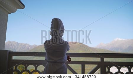 A Girl In A White Robe Stands On The Balcony And Enjoys. Sexy Girl In White Robe Stands On The Balco
