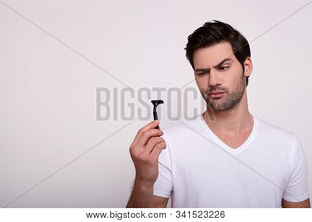 Spanish Man Looking Razor Against The Background. The Gorgeous Man Is Full Of Strength And Beauty, L