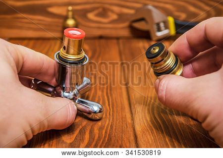Cruciform Hot And Cold Water Main Switch Of Spare Parts Holding In His Hands Master Plumber Before R
