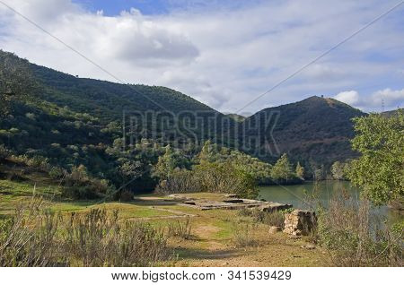 Green And Dirt Observation Deck With The Remains Of Stone Buildings. Green Hills, Lake And Firest. S