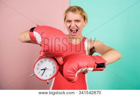 Punching A Clock. Time For Success. Win The Day. Angry Woman Boxing Gloves. Girl Boxer Hold Alarm Cl