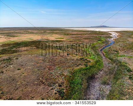 Small Red Water River Leading To Baskunchak Saline Lake In Nature Reserve