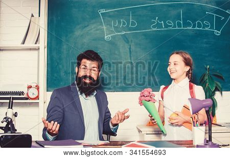 Flower Present For Best Teacher. Knowledge Day Is 1 September. Teachers Day. Daugghter And Father Wi