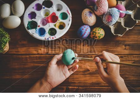 Young Girl Painting Easter Eggs For Eastertime At Home