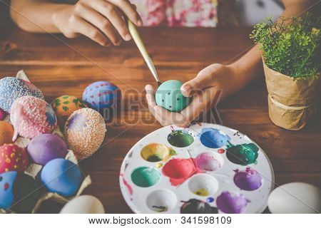Young Girl Painting Easter Eggs For Eastertime At Home