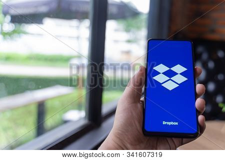 Chiang Mai, Thailand - Aug.24,2019: Man Holding Xiaomi Mi Mix 3 With Dropbox On Screen. Dropbox Is A