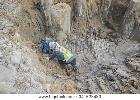 Two Workers Are Helping To Cut The Steel Wire By Gas In The Concrete Pile.
