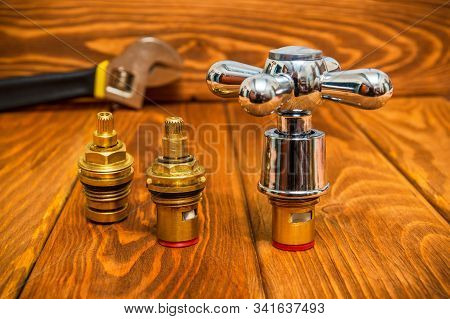 Cruciform Hot And Cold Water Main Switch Of Spare Parts On Vintage Wooden Boards