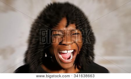 Eal Afro American Lady With Fleecy Hair Screams In Anger And Cries Against White Wall, Radial Blur