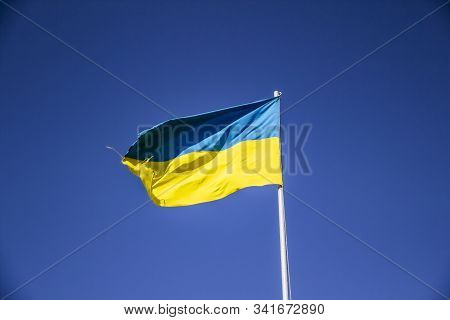 A Ukrainian Flag In The Blue Sky