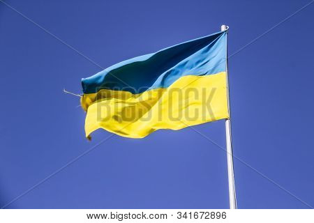 A Ukrainian Flag In The Blue Sky