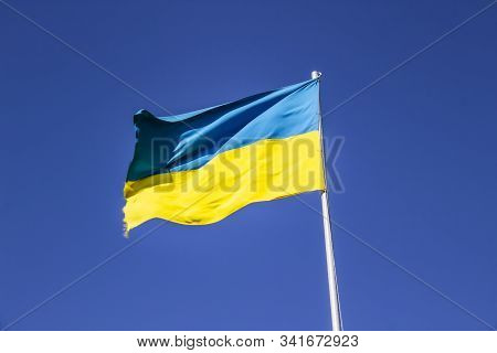 A Ukrainian Flag In The Blue Sky
