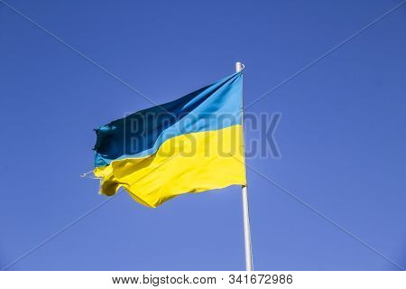 A Ukrainian Flag In The Blue Sky