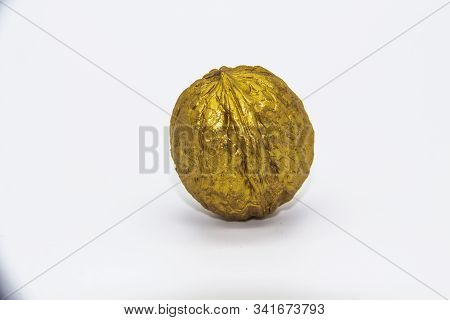 A Golden Walnut On A White Background