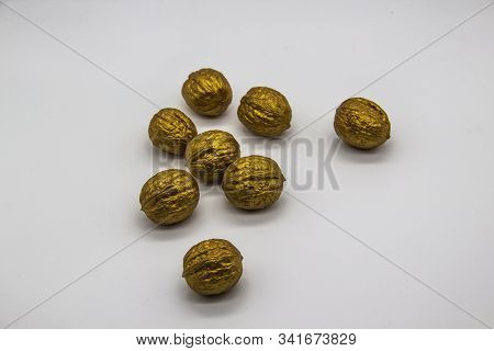 A Golden Walnuts On A White Background