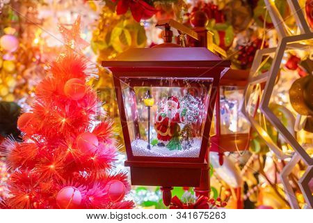 Christmas and New Year miniature house in the snow at night with Santa Claus. Holiday concept. 