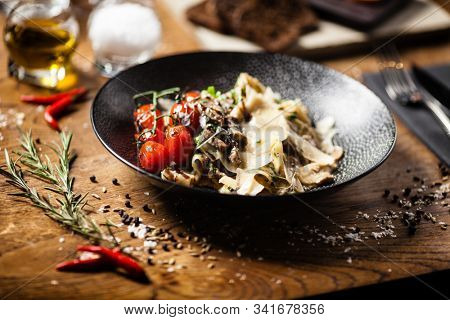 Black Angus pappardelle pasta with beef, champignon and parmegano cheese