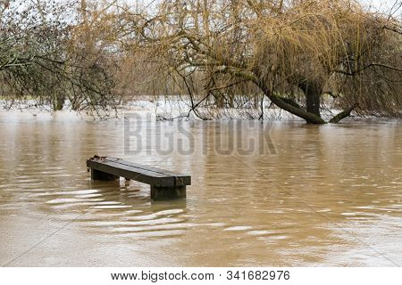 A Bench Becomes Part Of The River Mole In Brockham, Surrey, Uk, As Heavy Rain Caused Flooding In Sur