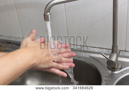 Both Hands Are Washing Their Hands In The Sink.hygiene Concept.