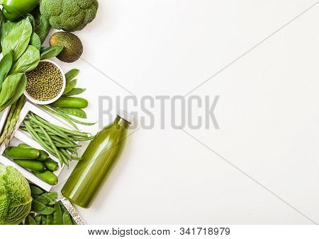 Assorted Green Toned Raw Organic Vegetables On White Stone Background. Avocado, Cabbage, Cauliflower