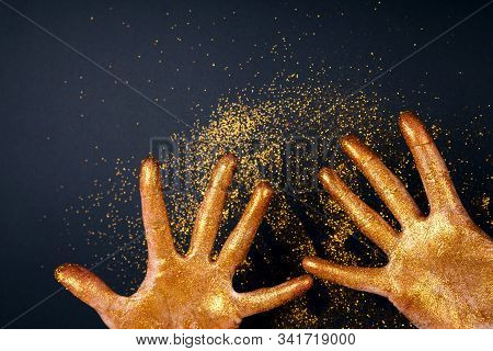 Beautiful Hands In Golden Paint On Black Fastive Background Close Up