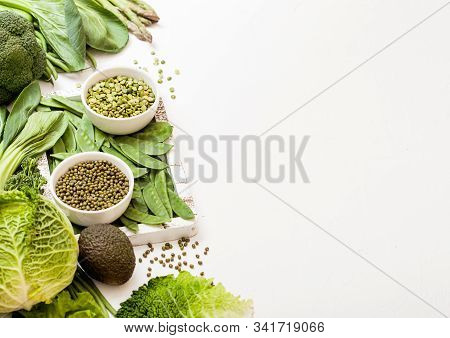 Assorted Green Toned Raw Organic Vegetables On White Background. Avocado, Cabbage, Broccoli, Caulifl