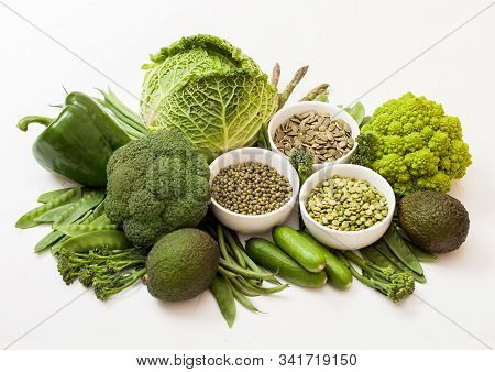Assorted Green Toned Raw Organic Vegetables On White Background. Avocado, Cabbage, Broccoli, Caulifl