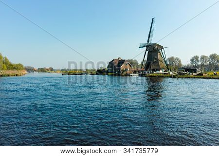 Waterways Of North Holland And View On Traditional Dutch Wind Mill, Dutch Lifestyle Landscape