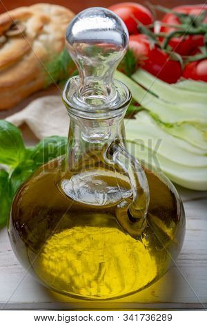Virgin Natural Olive Oil Is Glass Bottle, Served With Traditional Mediterranean Food, Fresh Tomatoes
