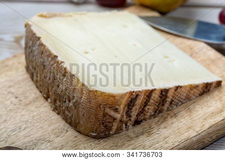 Piece Of French Cheese Tomme De Brebis Made From Sheep Milk Served As Dessert With Fresh Figs And Pe