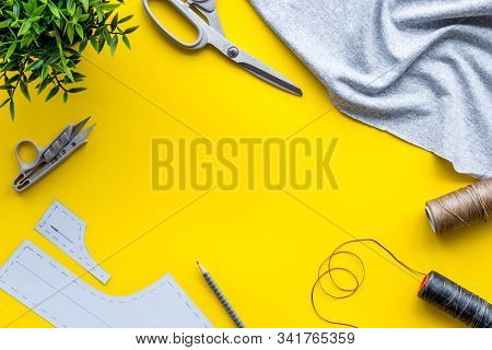 Sewing Wokrshop. Textile, Pattern, Scissors, Thread On Yellow Background Top-down Copy Space