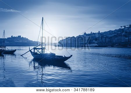 Boat On Water Of Duoro River In Porto, Portugal Toned In Trendy Classic Blue - Color Of The Year 202