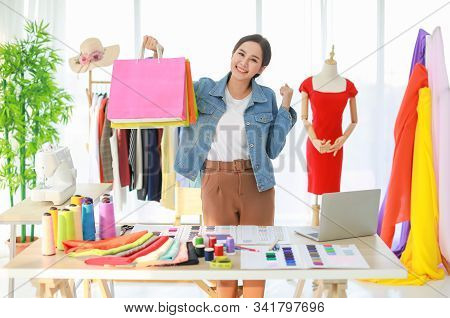 Young Beautiful Asian Fashion Designer Standing And Happy Because Her Collection Is Ready To Worldwi