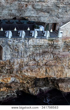 Polignano A Mare, Italy - September 17, 2019: The World-famous Grotta Palazzese Restaurant, Set In A