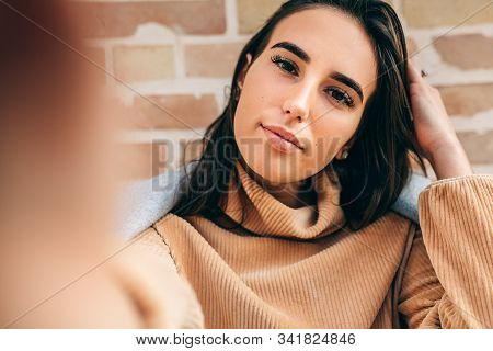 Close-up Image Of Beautiful Young Blonde Woman Smiling, Wearing Beige Sweater, Making Self Portrait 