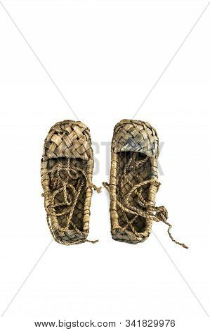 Old Russian Sandals Made Of Bark On A White Background.bast Shoes