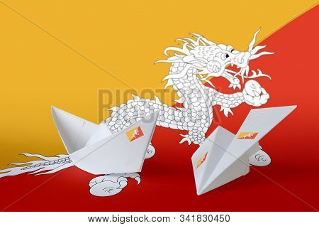 Bhutan Flag Depicted On Paper Origami Airplane And Boat. Handmade Arts Concept