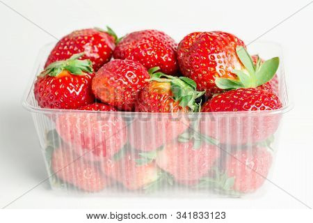 Fresh Red Strawberries Prepacked In A Plastic Transparent Container On White Background