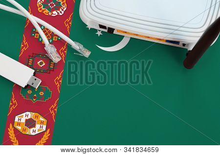 Turkmenistan Flag Depicted On Table With Internet Rj45 Cable, Wireless Usb Wifi Adapter And Router. 