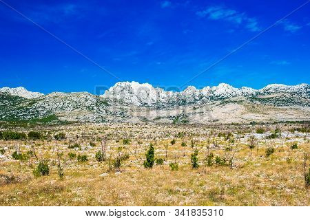 Dalmatian Inland Landscape And Velebit Mountain In Background In Croatia