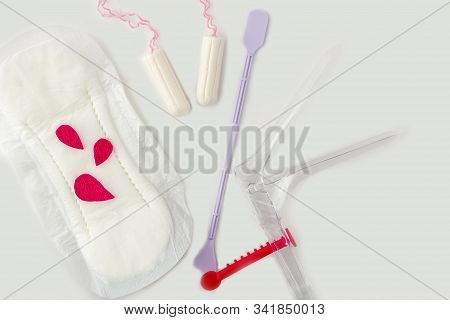 Protective Menstrual Pads, Cotton Tampons, Gynecologic Speculum
On White Background.  Medical Equipm