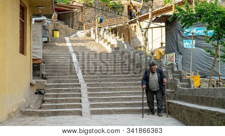 Masuleh, Iran - May 2019: Old Iranian Man Walking In The Roads Of Traditional Masuleh Village