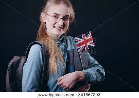 Smiling Student Posing With Books, Daypack And British Flag