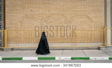 Qom, Iran - May 2019: Unidentified Iranian Man Walking A Street In Qom, Which Is Considered By Shia 